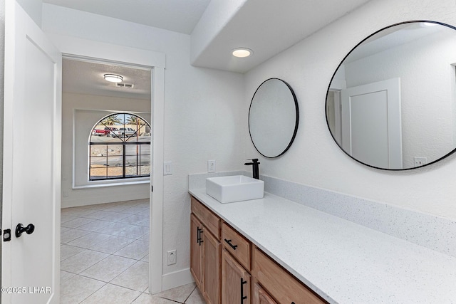 bathroom featuring tile patterned flooring and vanity