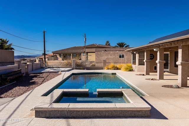 view of swimming pool with an in ground hot tub and a patio