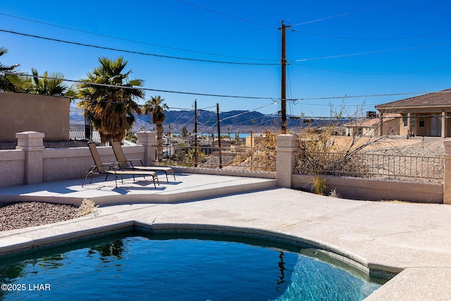 view of pool with a mountain view and a patio