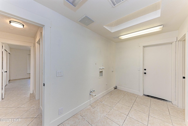 washroom featuring washer hookup, hookup for a gas dryer, a textured ceiling, and light tile patterned floors