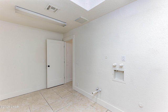 clothes washing area with gas dryer hookup, washer hookup, and light tile patterned floors