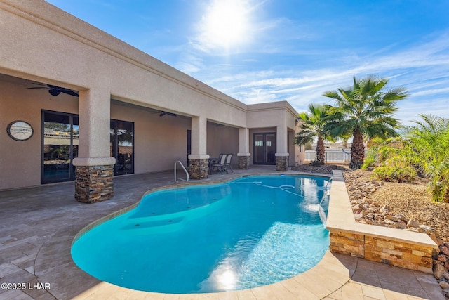 pool featuring ceiling fan and a patio