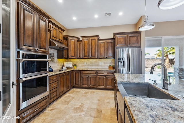 1589 Park Terrace Ave, Lake Havasu City, AZ 86404 - kitchen with light stone counters, decorative light fixtures, visible vents, appliances with stainless steel finishes, and a sink