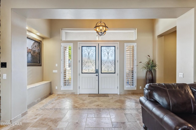 1589 Park Terrace Ave, Lake Havasu City, AZ 86404 - entrance foyer featuring stone tile flooring, baseboards, and an inviting chandelier