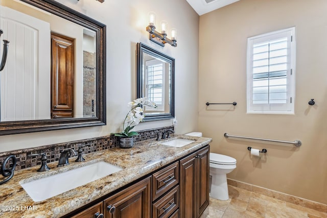 1589 Park Terrace Ave, Lake Havasu City, AZ 86404 - bathroom featuring double vanity, tasteful backsplash, a sink, and toilet