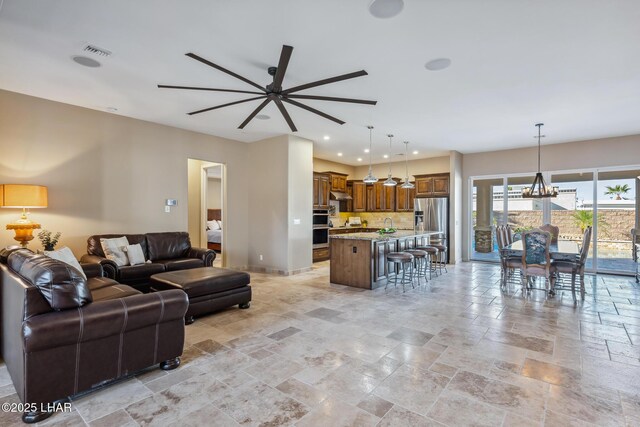 1589 Park Terrace Ave, Lake Havasu City, AZ 86404 - living room with stone tile floors, recessed lighting, visible vents, baseboards, and ceiling fan with notable chandelier