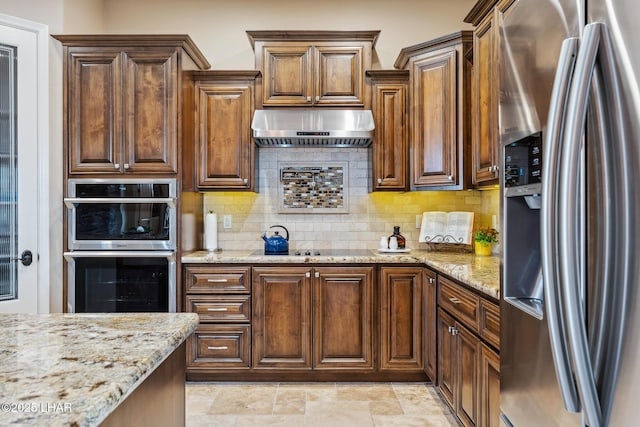 1589 Park Terrace Ave, Lake Havasu City, AZ 86404 - kitchen with tasteful backsplash, range hood, light stone counters, and stainless steel appliances
