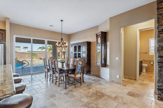 1589 Park Terrace Ave, Lake Havasu City, AZ 86404 - dining area with a notable chandelier, baseboards, visible vents, and stone tile floors