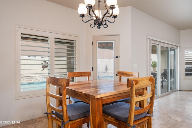 dining space featuring plenty of natural light and a notable chandelier