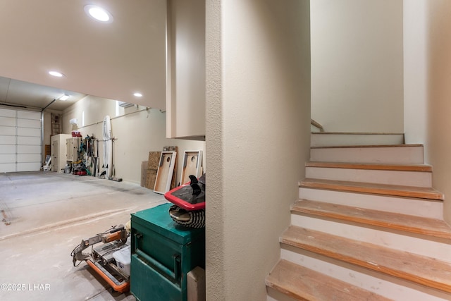 staircase featuring concrete floors