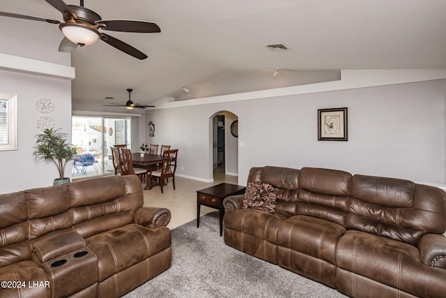 living room featuring lofted ceiling, light tile patterned floors, and ceiling fan