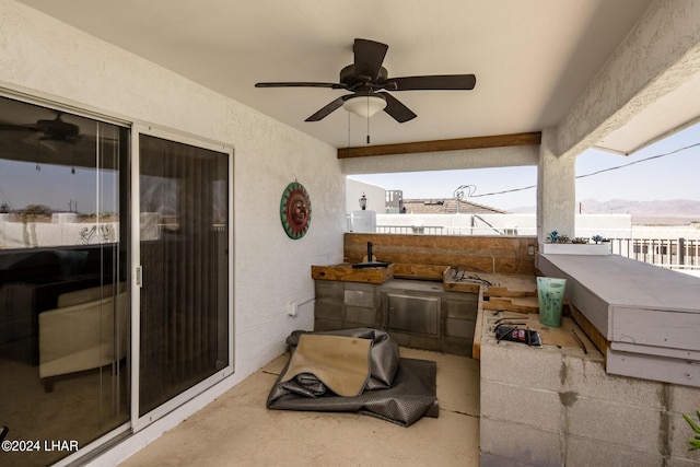 view of patio featuring a mountain view and ceiling fan