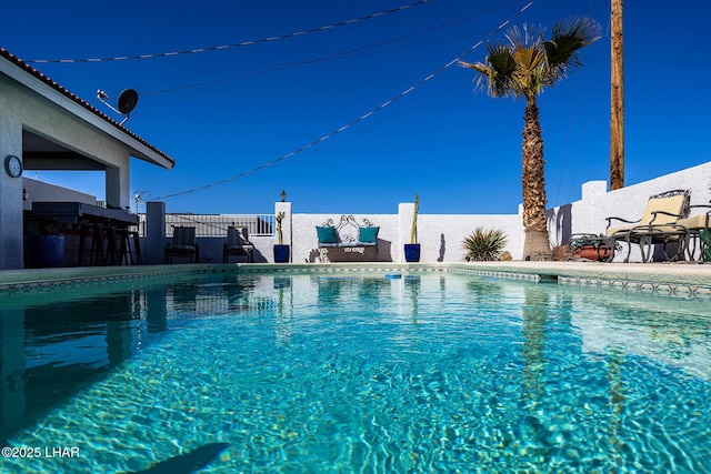 view of swimming pool featuring fence and a fenced in pool