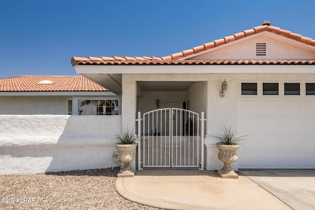 mediterranean / spanish-style house with a garage