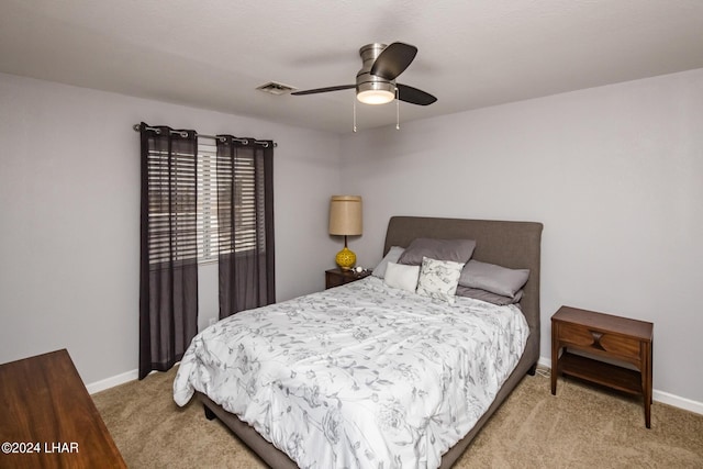 bedroom with light carpet and ceiling fan