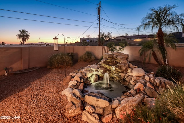 879 Window Rock Plz, Lake Havasu City, AZ 86406 - yard at dusk with a fenced backyard