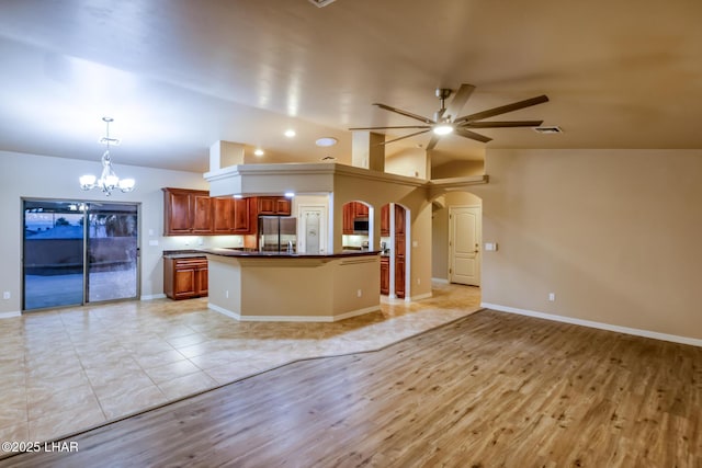 879 Window Rock Plz, Lake Havasu City, AZ 86406 - kitchen with open floor plan, dark countertops, arched walkways, a ceiling fan, and lofted ceiling
