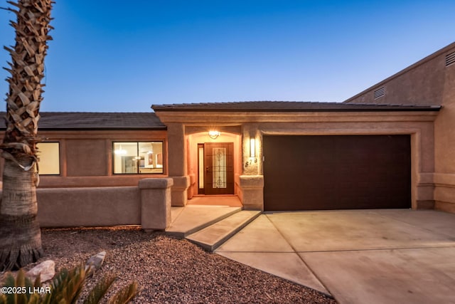 879 Window Rock Plz, Lake Havasu City, AZ 86406 - view of front facade featuring concrete driveway, an attached garage, and stucco siding