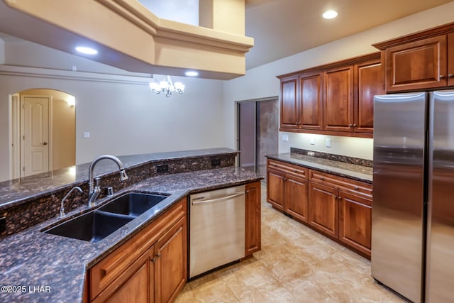 879 Window Rock Plz, Lake Havasu City, AZ 86406 - kitchen with stainless steel appliances, arched walkways, dark stone counters, recessed lighting, and brown cabinets