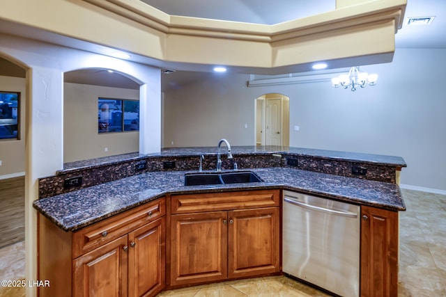 879 Window Rock Plz, Lake Havasu City, AZ 86406 - kitchen featuring stainless steel dishwasher, arched walkways, brown cabinetry, and dark stone counters