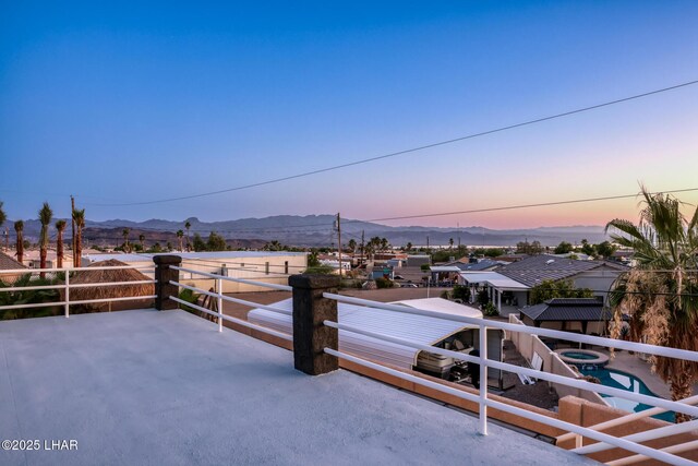 879 Window Rock Plz, Lake Havasu City, AZ 86406 - patio terrace at dusk with a mountain view, a balcony, and a pool with connected hot tub