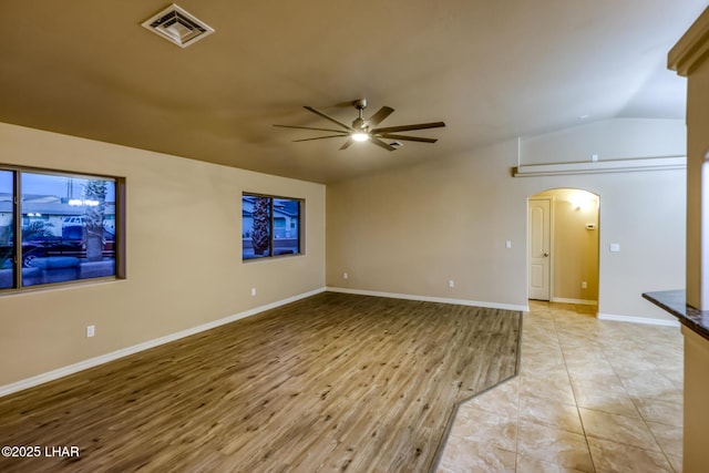 879 Window Rock Plz, Lake Havasu City, AZ 86406 - empty room with arched walkways, ceiling fan, vaulted ceiling, and light wood-type flooring
