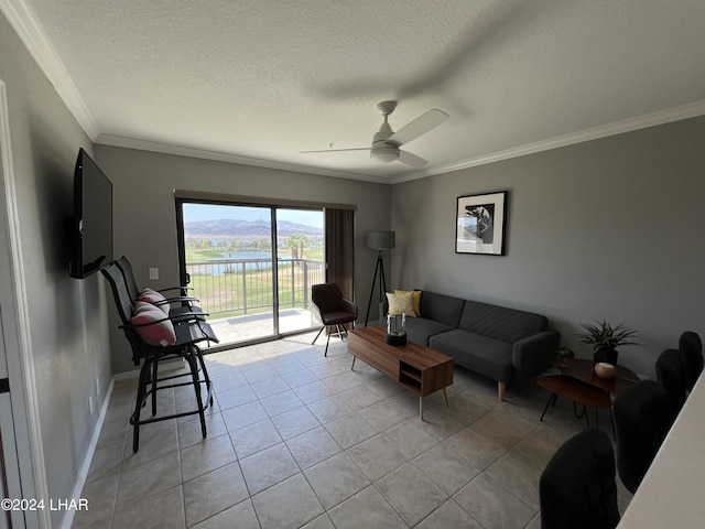 living room featuring crown molding, light tile patterned floors, a textured ceiling, and ceiling fan