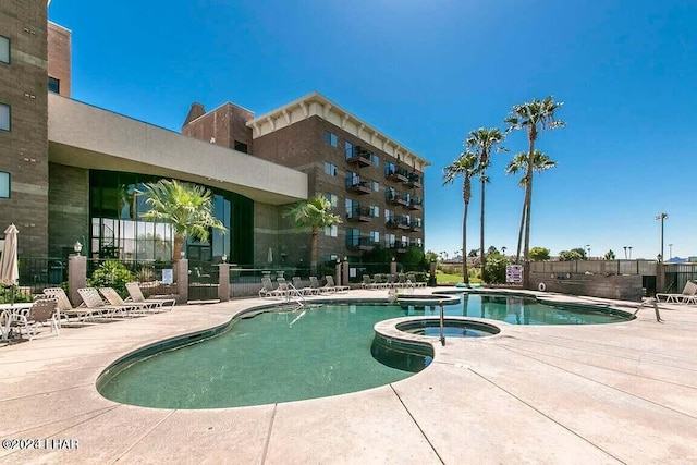 view of swimming pool with a community hot tub and a patio