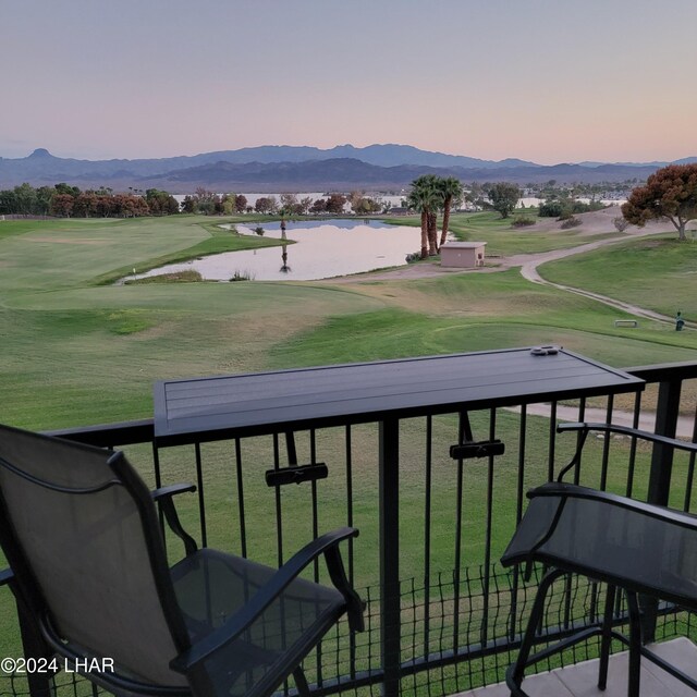 balcony at dusk with a water and mountain view