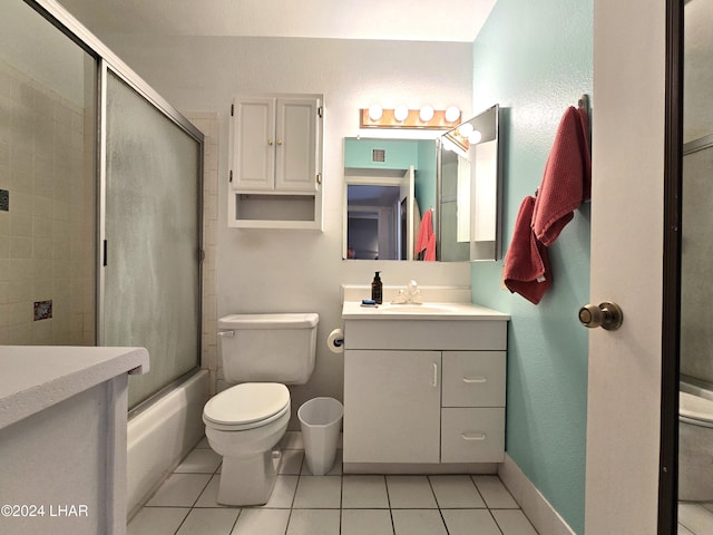 full bathroom with vanity, tile patterned flooring, enclosed tub / shower combo, and toilet