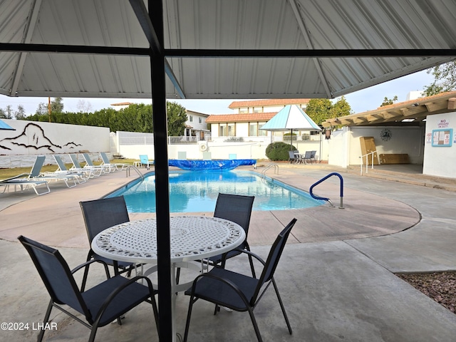 view of swimming pool with a gazebo and a patio