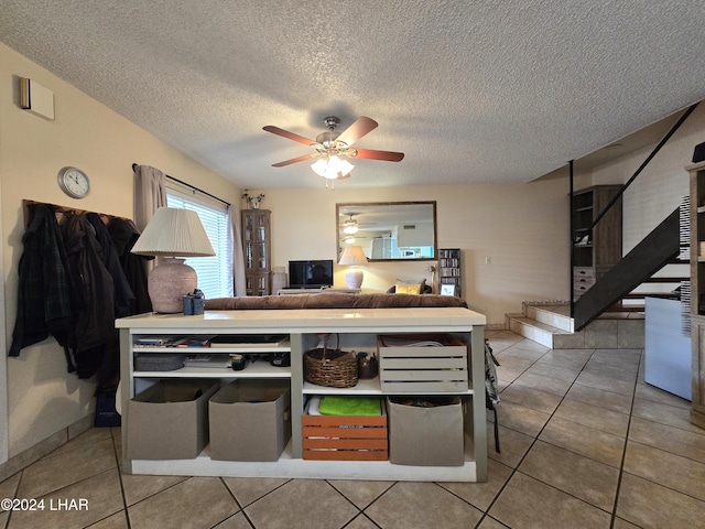 kitchen featuring tile patterned flooring, ceiling fan, and a textured ceiling