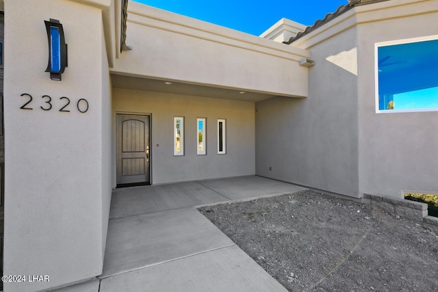 entrance to property featuring a patio area