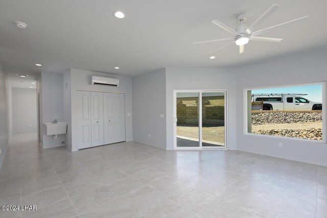 interior space featuring ceiling fan and a wall unit AC