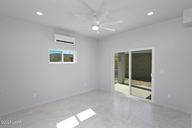 spare room with a wall mounted AC and ceiling fan