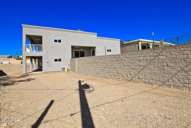 back of property featuring a balcony and central AC unit