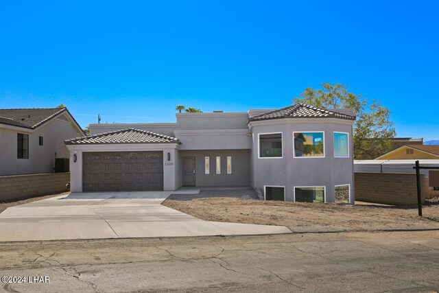 view of front of home with central AC and a garage