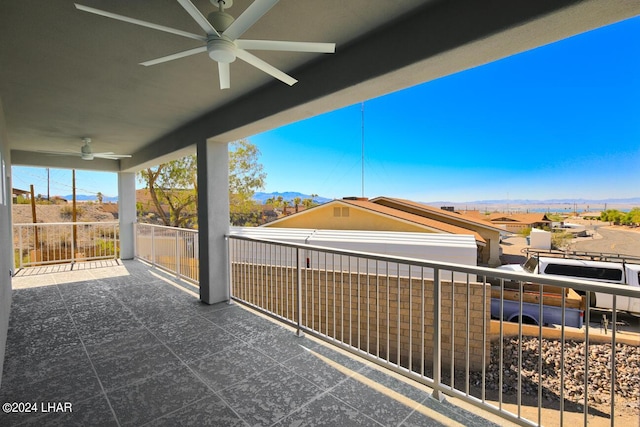 view of patio / terrace with a mountain view, a balcony, and ceiling fan