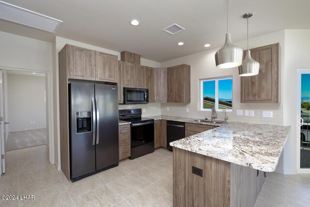 kitchen featuring sink, hanging light fixtures, black appliances, decorative backsplash, and kitchen peninsula