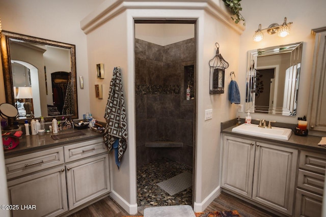 2870 Havasupai Blvd, Lake Havasu City, AZ 86404 - bathroom featuring two vanities, walk in shower, baseboards, and wood finished floors