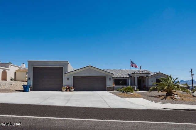 2870 Havasupai Blvd, Lake Havasu City, AZ 86404 - view of front of house featuring a garage, stucco siding, concrete driveway, and a tile roof
