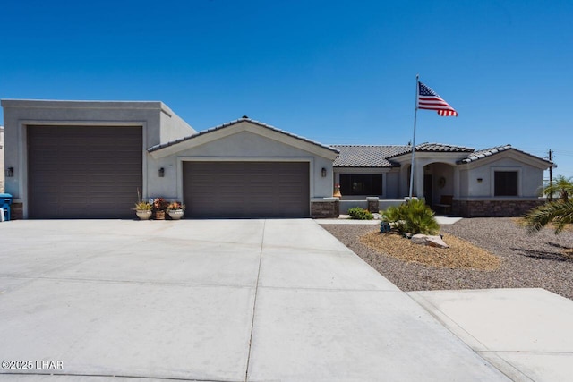 2870 Havasupai Blvd, Lake Havasu City, AZ 86404 - view of front facade featuring an attached garage, concrete driveway, stucco siding, and a tile roof