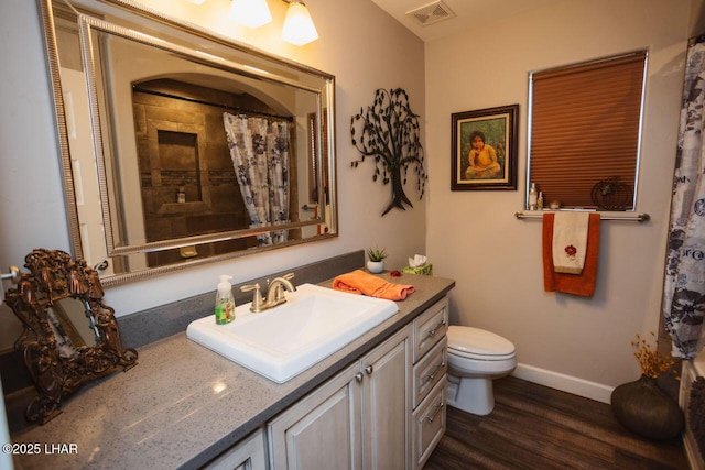 2870 Havasupai Blvd, Lake Havasu City, AZ 86404 - bathroom featuring wood finished floors, vanity, toilet, baseboards, and a shower with shower curtain