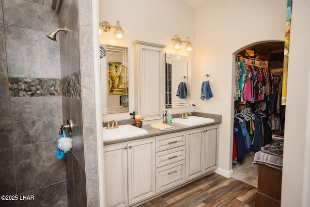 2870 Havasupai Blvd, Lake Havasu City, AZ 86404 - bathroom with wood finished floors, double vanity, a tile shower, and a walk in closet