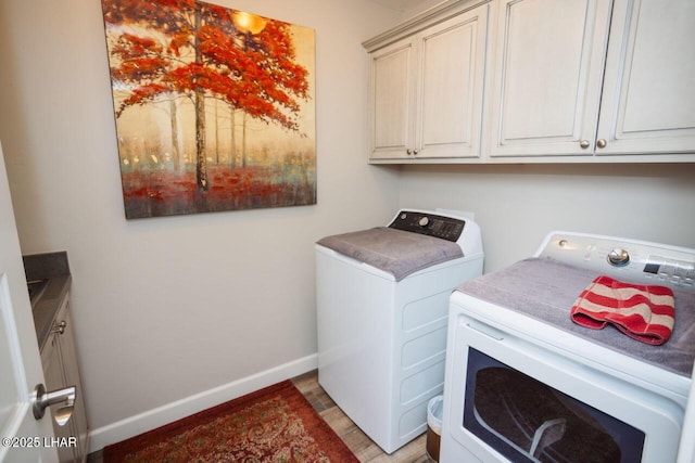 2870 Havasupai Blvd, Lake Havasu City, AZ 86404 - laundry area featuring washing machine and clothes dryer, cabinet space, light wood-type flooring, and baseboards