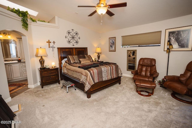 2870 Havasupai Blvd, Lake Havasu City, AZ 86404 - carpeted bedroom with arched walkways, baseboards, ensuite bath, and a ceiling fan