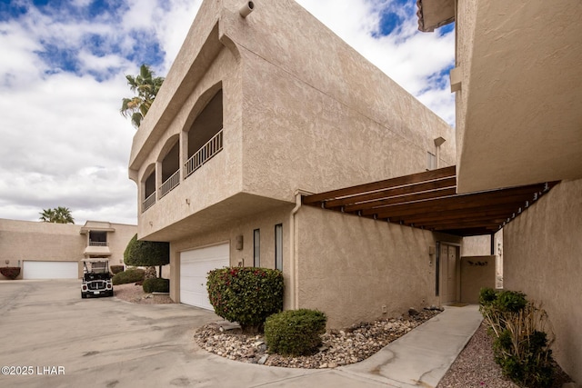 view of home's exterior with stucco siding and an attached garage