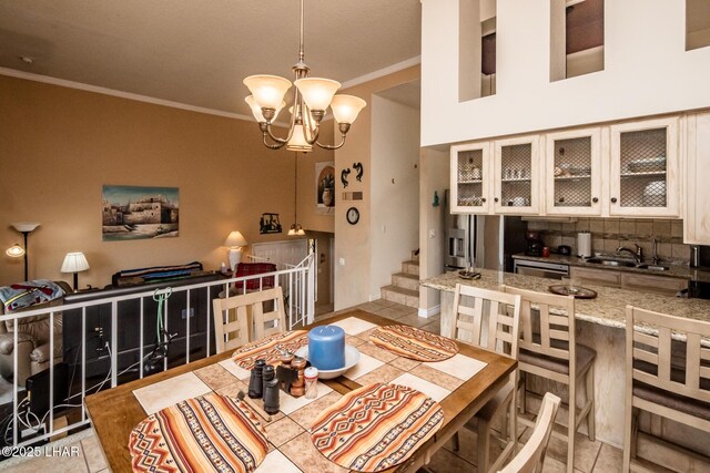 tiled dining room with crown molding, stairway, a notable chandelier, and a sink