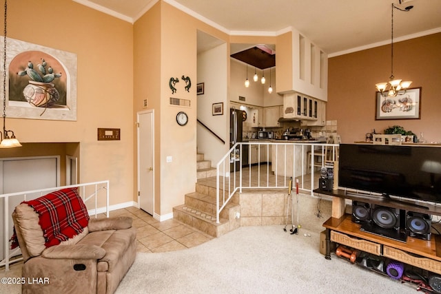 carpeted living area with visible vents, crown molding, baseboards, a chandelier, and stairs