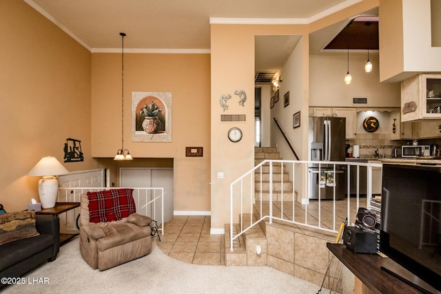 living area with crown molding, baseboards, stairs, light tile patterned floors, and light carpet